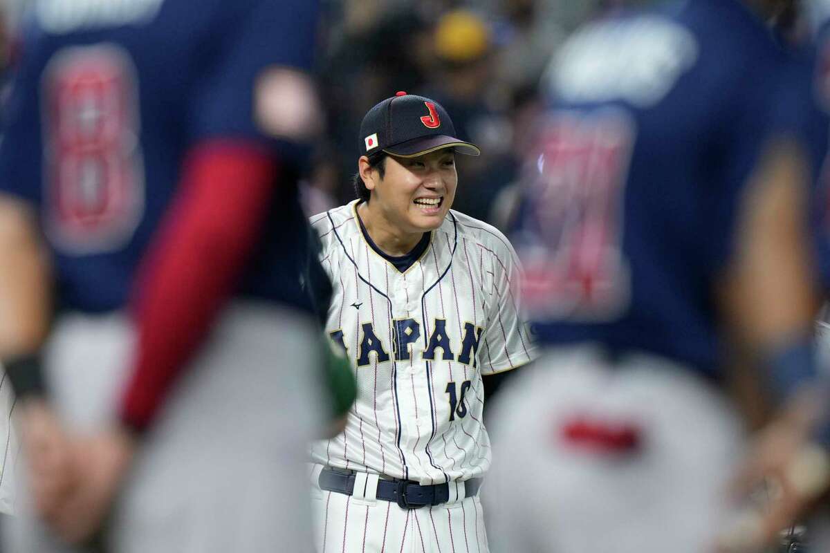 Japan player Shohei Ohtani (16) smiles during the player introduction before the World Baseball Classic championship game against the United States, Tuesday, March 21, 2023, in Miami.
