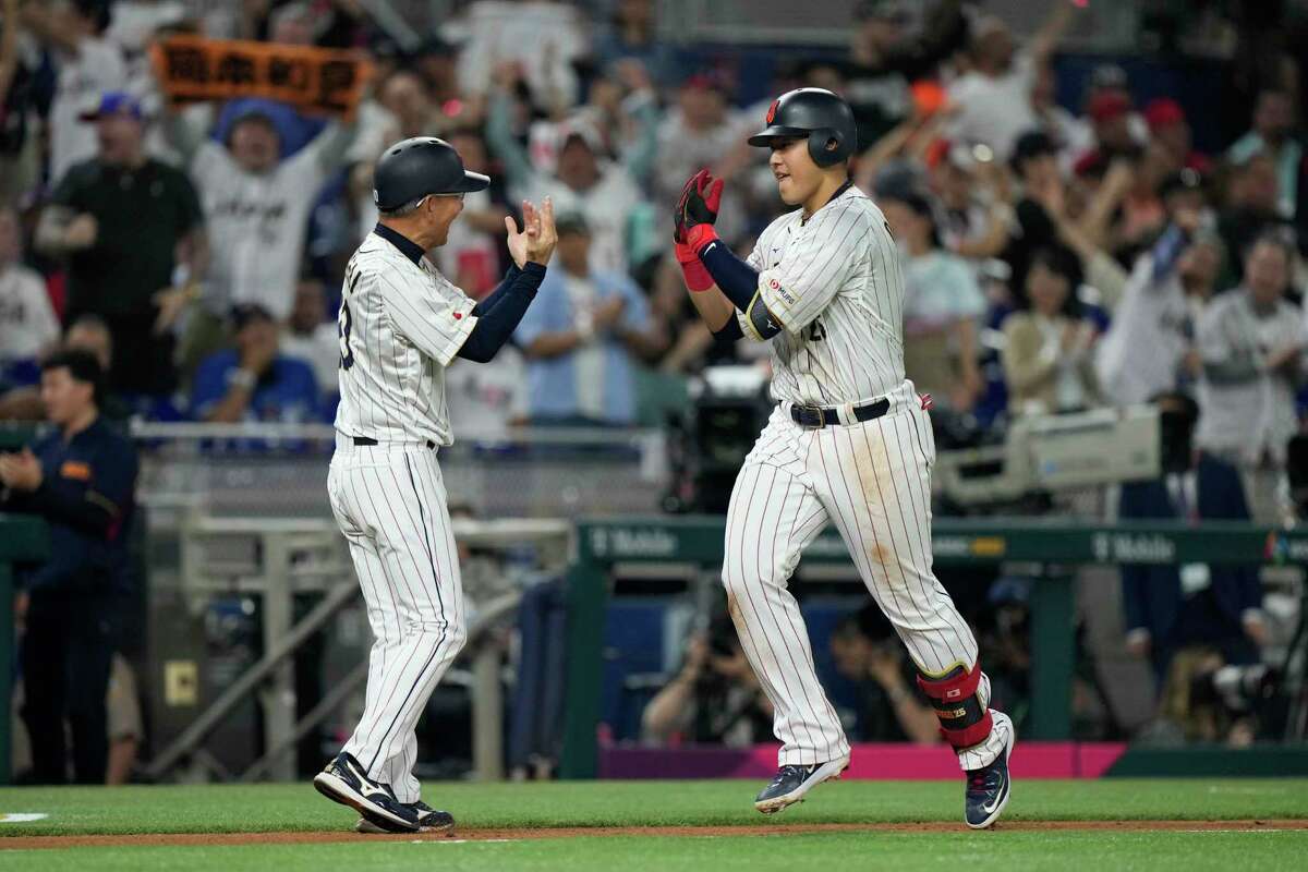 Japan's Kazuma Okamoto (25) celebrates after hitting a home run during fourth inning of a World Baseball Classic championship game against the United States, Tuesday, March 21, 2023, in Miami.