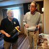 Jon Gatrell, left, and Mike Kaltschnee with plastic face shields provided by volunteers with Danbury Hackerspace at the outset of the COVID-19 pandemic, on Tuesday, March 21, 2023, at the former Crowne Plaza Danbury hotel in Danbury, Conn.  A developer is seeking city permission to convert the hotel into the Bright Ravens Innovation Center with nearly 200 apartments on the upper levels.