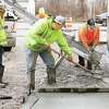 Workers pour a concrete sidewalk Wednesday around the building at 1400 E. Broadway that will be Alton's first marijuana dispensary. As renovations to the Alton building continue, a competitor plans to open in Edwardsville in April and a dispensary is being planned for downtown Wood River as well.