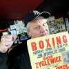 Former boxer Dave "Ziggy" Zyglewicz shows his boxing style while holding a poster from 1972 on Saturday, April 18, 2009, at Ziggy's Sports Bar in Latham, N.Y. Zyglewicz lost to heavyweight champ Joe Frazier 40 years ago. The bar is owned by his son, Shane. (Cindy Schultz / Times Union)