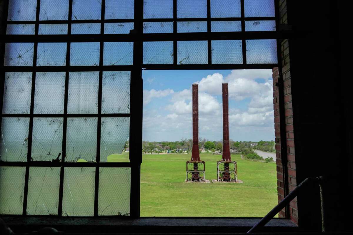 A view from inside the Imperial Char House showing two old smoke stacks. Much of the grassy area is expected to be house apartments in new buildings.
