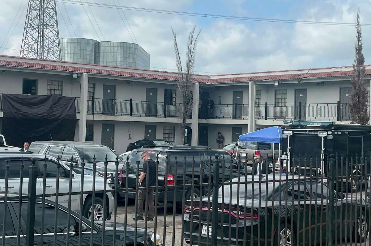 The FBI works on the scene of a shooting, Thursday, March 23, 2023 in north Houston. Officials say one person has been fatally shot during a hostage rescue in Houston. In a statement, the FBI's Houston office said agents had been part of a multiday law enforcement operation to rescue a group of hostages. (Ralph Green/Houston Chronicle via AP)