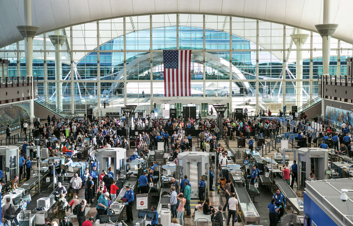 TSA security lines in the main terminal are crowded with spring break travelers on April 12, 2017, in Denver, Colo.