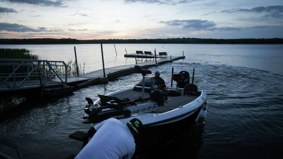 Cody Miller, left, and Robert Budenbender load up their boat Wednesday March 22, 2023, at Fairfield Lake State Park in Fairfield. The pair are friends from high school who planned an annual trip to the lake. They changed their reservations when state officials closed the state park recently. When the park reopened temporarily, they chose to drive over two hours each way to fish at the lake, instead of another lake where they are staying.