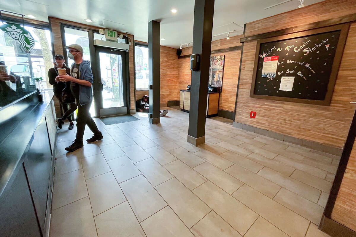 A customer walks to get their order inside a Starbucks store on 18th Street in the Castro District where all the chairs for customers have been removed in San Francisco, Calif. on March 23, 2023.
