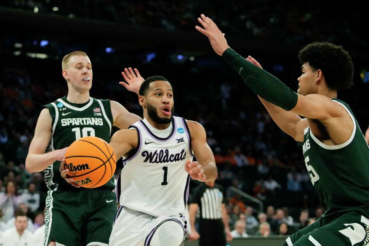 Kansas State guard Markquis Nowell (1) passes around the defense of Michigan State forward Malik Hall in the second half of a Sweet 16 college basketball game in the East Regional of the NCAA tournament at Madison Square Garden, Thursday, March 23, 2023, in New York.
