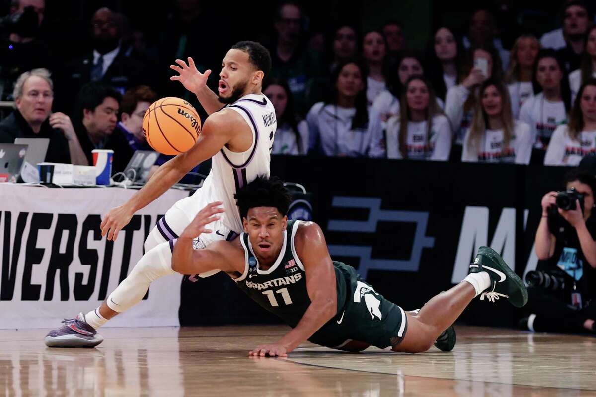 Michigan State guard A.J. Hoggard (11) and Kansas State guard Markquis Nowell (1) reach for the loose ball in the second half of a Sweet 16 college basketball game in the East Regional of the NCAA tournament at Madison Square Garden, Thursday, March 23, 2023, in New York.