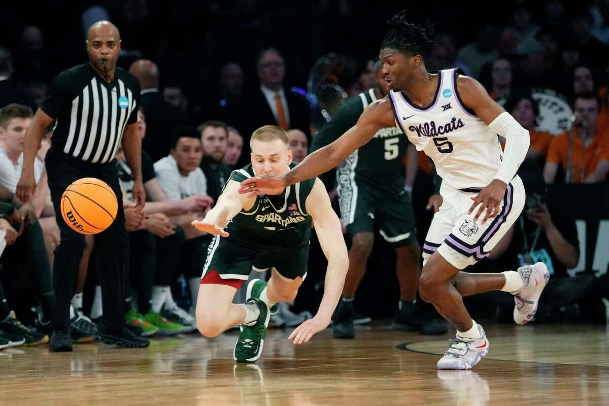 Michigan State forward Joey Hauser (10) and Kansas State guard Cam Carter (5) chase the loose ball in the second half of a Sweet 16 college basketball game in the East Regional of the NCAA tournament at Madison Square Garden, Thursday, March 23, 2023, in New York.