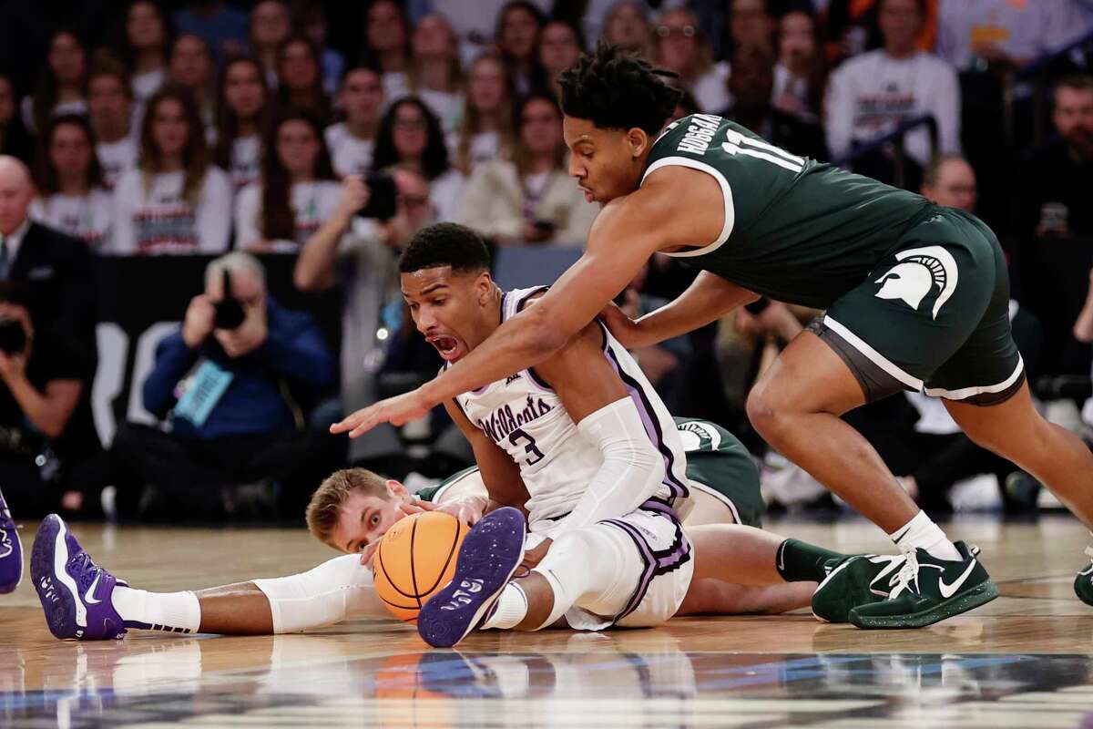 Kansas State forward David N'Guessan (3) and Michigan State guard A.J. Hoggard (11) reach for the loose ball in the first half of a Sweet 16 college basketball game in the East Regional of the NCAA tournament at Madison Square Garden, Thursday, March 23, 2023, in New York.