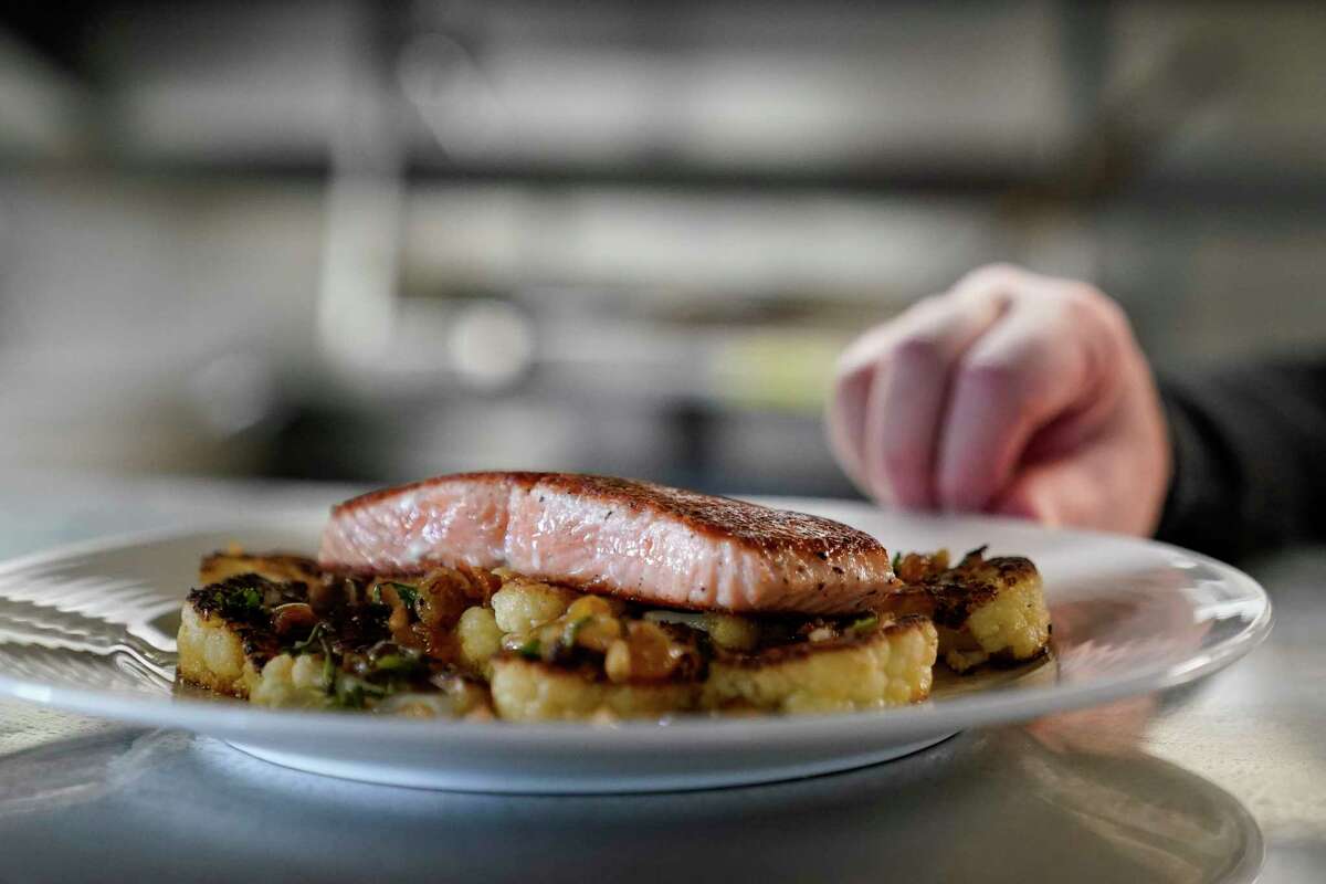 A farm-raised salmon dish at Scoma's can be seen before being served to a customer in San Francisco, Monday, March 20, 2023. On April 7, the Pacific Fishery Management Council, the regulatory group that advises federal officials, will take action on what to do about the 2023 season for both commercial and recreational salmon fishing.