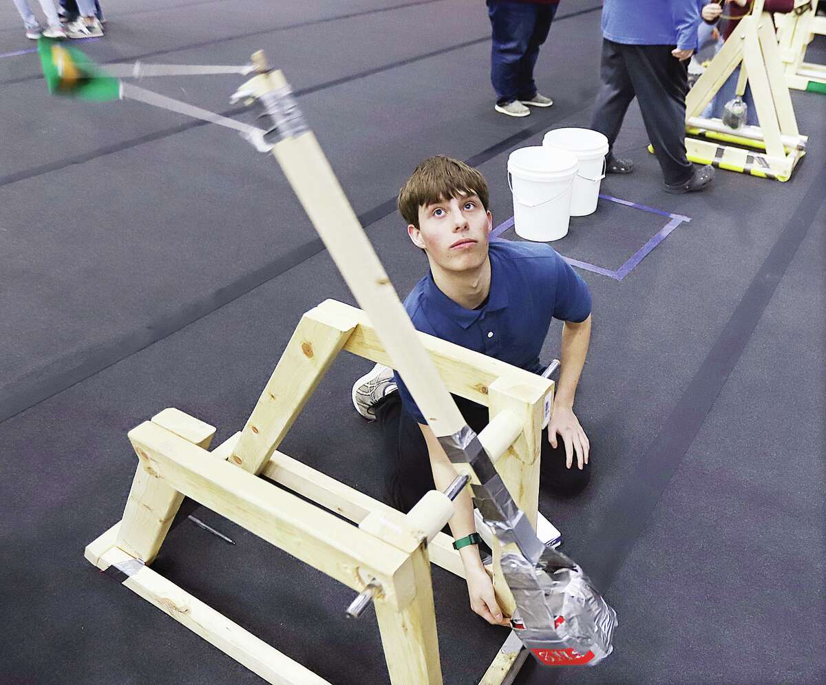  Jacob Schaper, of Alton, a member of the competition's first-ever home schooled team, launches a practice squash ball Friday during the 16th Annual Trebuchet Competition at L&CCC in Godfrey.