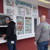 Two customers stop by Overton's Seafood in Norwalk, which opened for the season on Friday, March 24, 2023. 