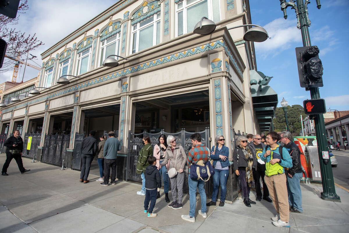 Customers line up outside Pizzeria da Laura before opening for dinner service for the first time in Berkeley, Calif., on March 23, 2023.