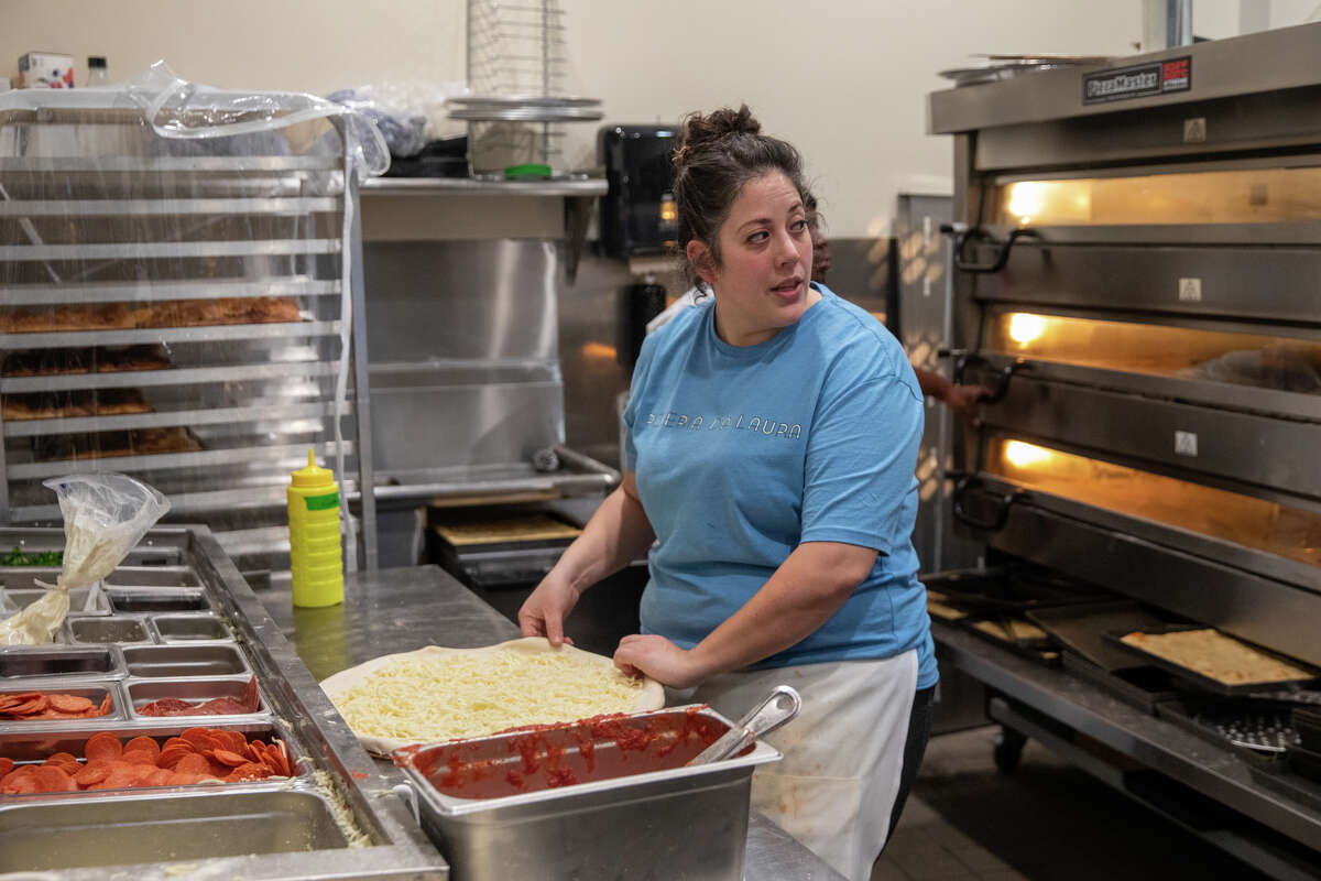 Pizzeria da Laura owner Laura Meyer shapes a pizza in the kitchen of her pizzeria in Berkeley, Calif. on March 23, 2023.