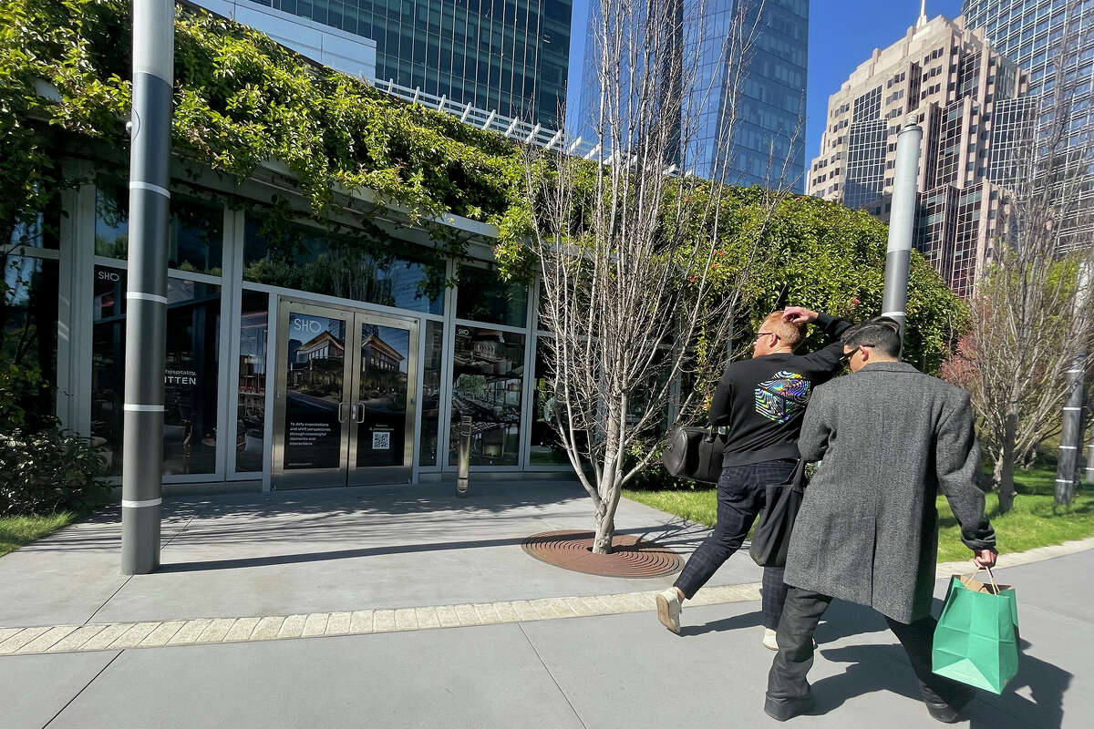 Pedestrians walk past the proposed Sho Restaurant site in Salesforce Park, Thursday, March 16, 2023. 