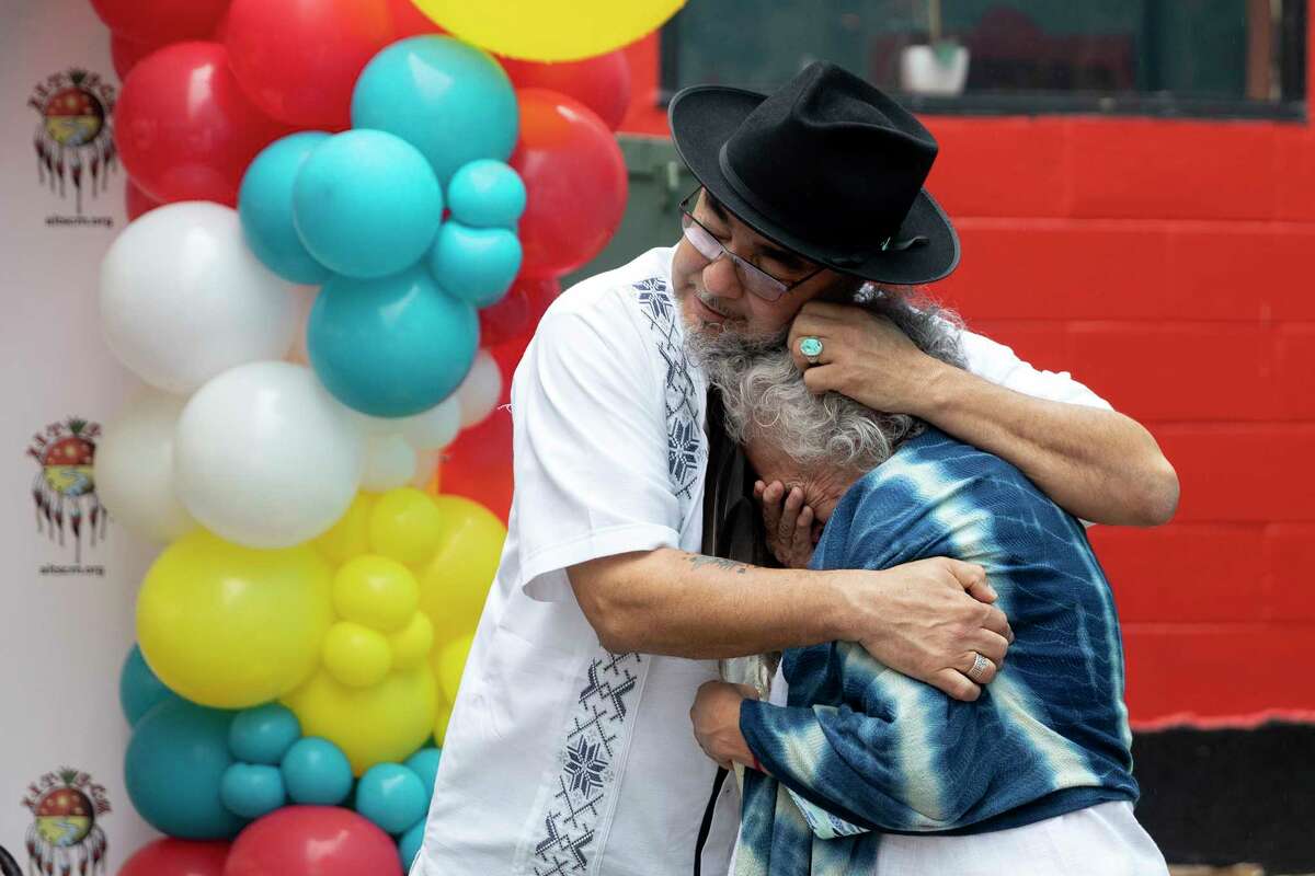 Ramón J. Vásquez, executive director of the American Indians in Texas at the Spanish Colonial Missions, embraces Gloria Camarillo-Vasquez, Tribal Elder of the Tap Pilam Nation, who became emotional after speaking at the opening the American Indians of Texas at South Missions Center.