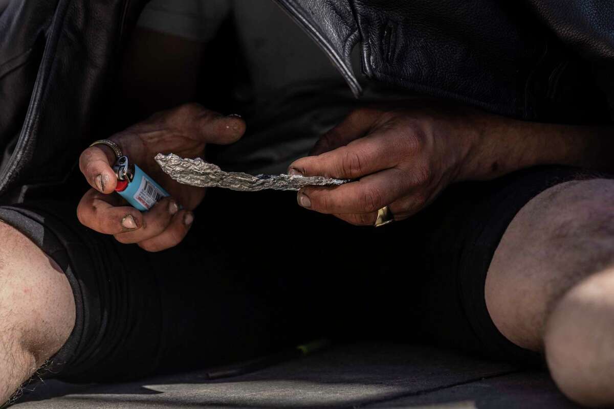 Peter Taylor, 23, smokes fentanyl on Minna Street near the shuttered Minna Hotel in the SOMA district of San Francisco, California Tuesday, March 22, 2022. Taylor, who is originally from San Jose, has been using fentanyl for about 10 months.