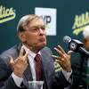 Baseball commissioner Bud Selig, left, gestures during a news conference prior to a baseball game between the New York Mets and the Oakland Athletics on Tuesday, Aug. 19, 2014, in Oakland, Calif. At right is Oakland Athletics co-owner Lewis Wolff. (AP Photo/Ben Margot)