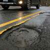 A view of a pothole along Chestnut Hill Road in Stamford, Conn., on Saturday March 25, 2022.
