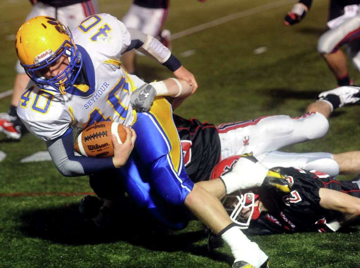 Seymour's Damien Granda is brought down during Friday's game at New Canaan High School on October 15, 2010.
