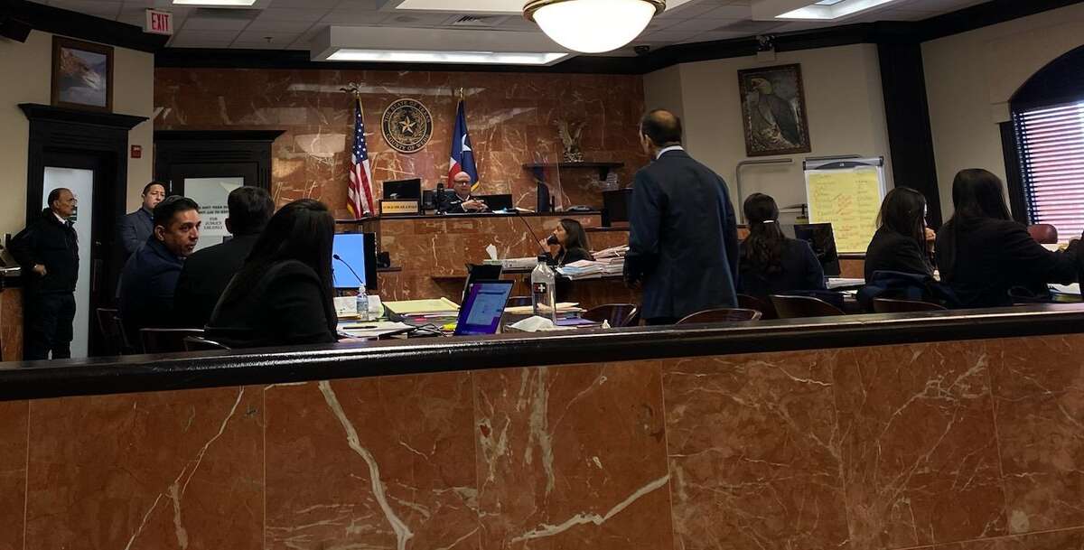 Joel Pellot, sitting on left, talks to the defense during his murder trial in Webb County's 406th District Court in Laredo, Texas on Tuesday, March 28, 2023.