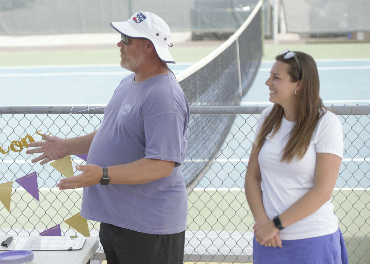 New Midland High tennis coach Devon Lowe, right, is introduced by her predecessor Tom Heiting, left, on March 23 at the Midland High tennis courts. 