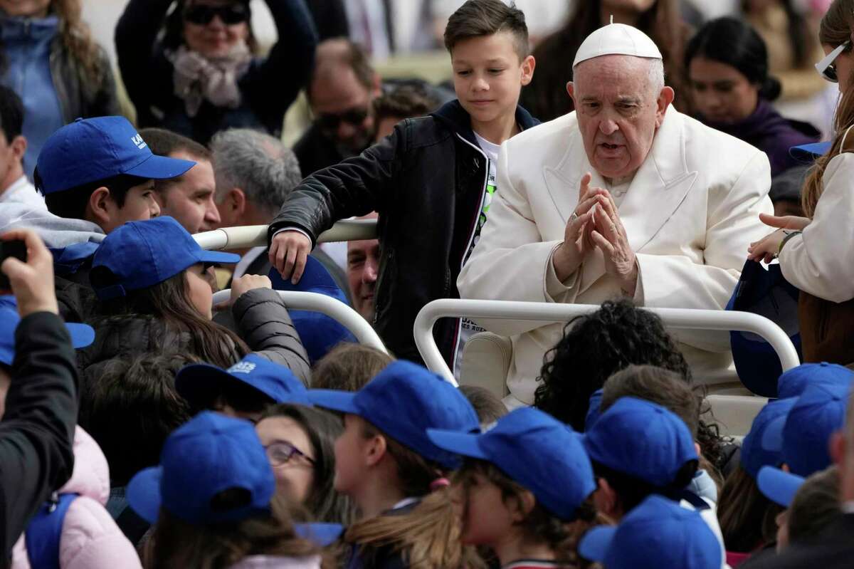 Pope Francis meets children at the end of his weekly general audience in St. Peter's Square, at the Vatican, Wednesday, March 29, 2023.