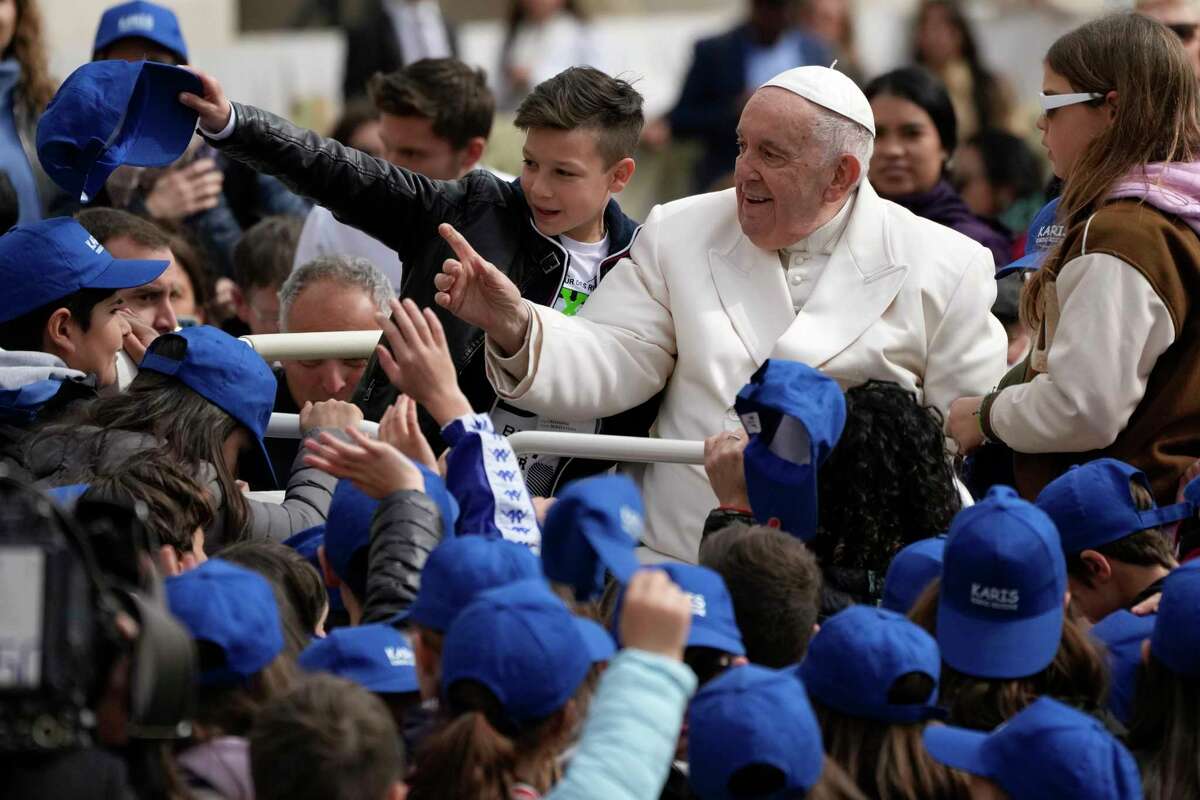 Pope Francis meets children at the end of his weekly general audience in St. Peter's Square, at the Vatican, Wednesday, March 29, 2023.