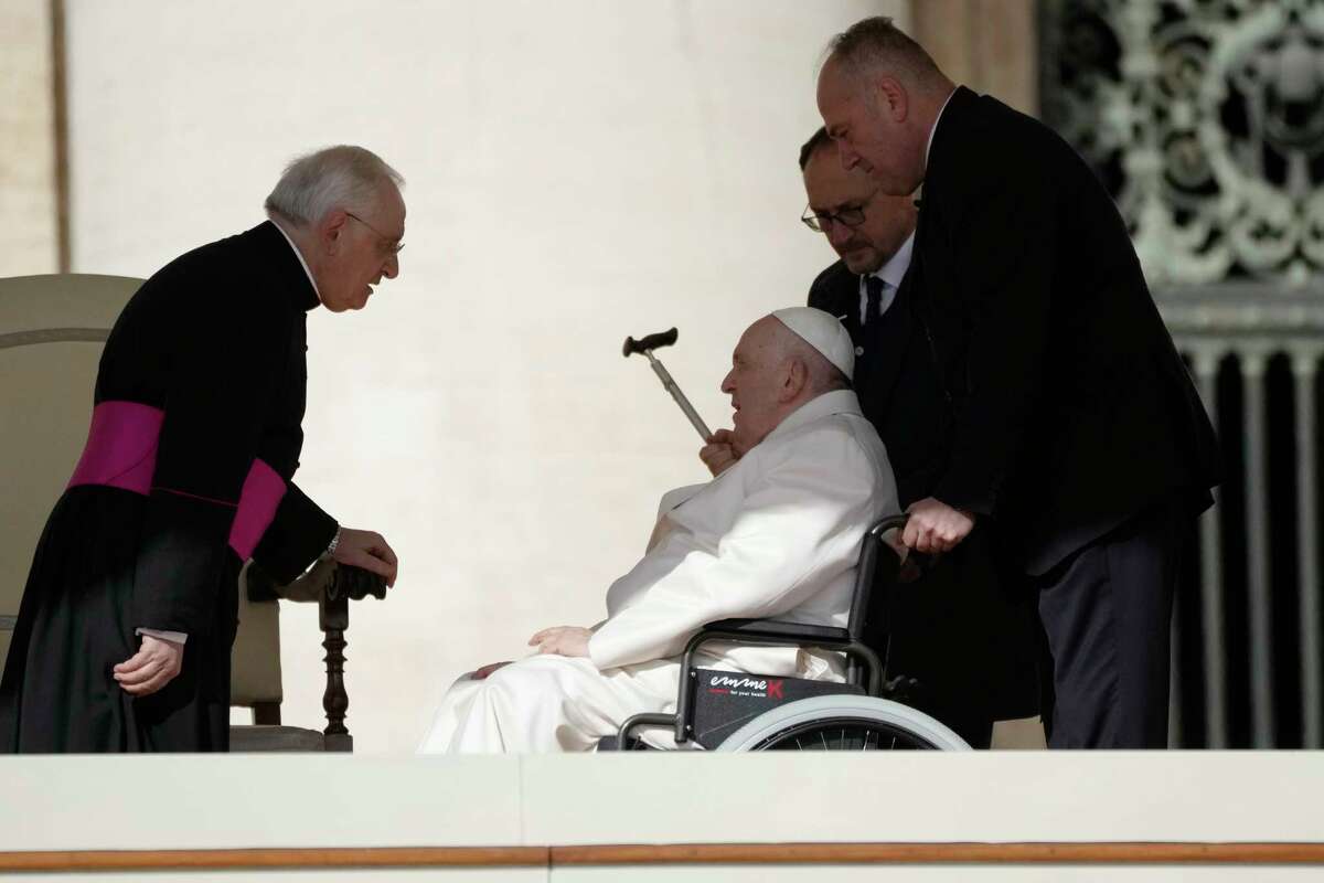 Pope Francis talks with Monsignor Leonardo Sapienza during his weekly general audience in St. Peter's Square, at the Vatican, Wednesday, March 29, 2023.
