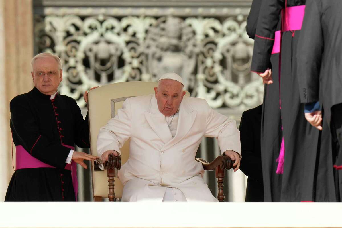 Pope Francis holds his weekly general audience with Monsignor Leonardo Sapienza, left, in St. Peter's Square, at the Vatican, Wednesday, March 29, 2023.