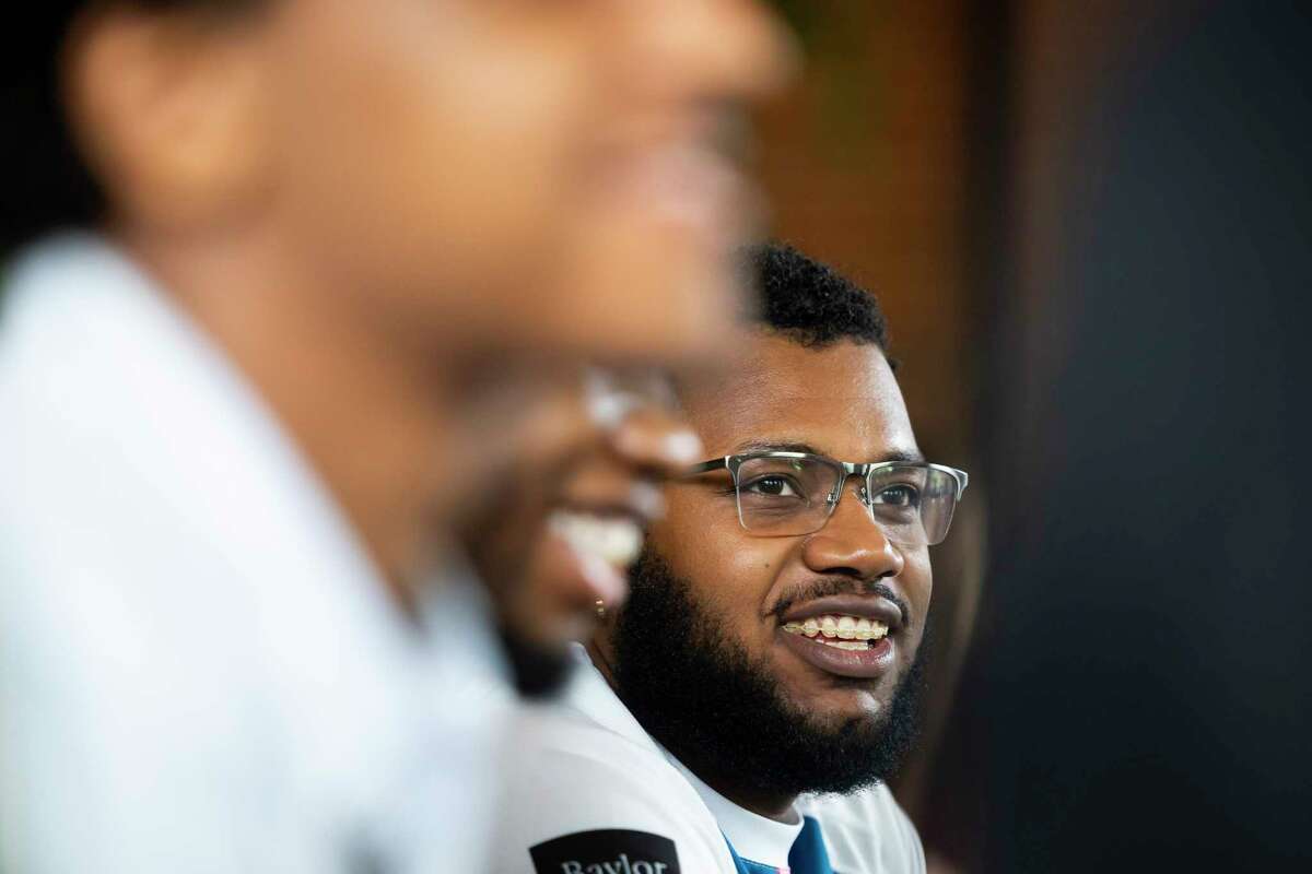 Second-year medical student Jamie Provost listens during a casual gathering of members of the Baylor College of Medicine chapter of Black Men in White Coats at Brass Tacks coffee shop on Sunday, March 26, 2023.