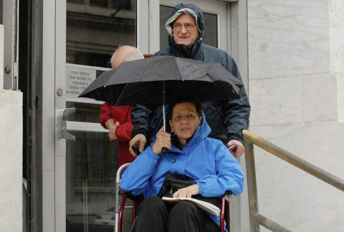 Angeline J. Cacchillo and her husband, Robert, leave the federal courthouse Oct. 16 in Albany. Angeline Cacchillo, a retired school teacher from Schenectady, has a rare muscular dystrophy disease and was seeking court-ordered access to a trial drug that she said was stemming her disease. (Michael P. Farrell / Times Union)