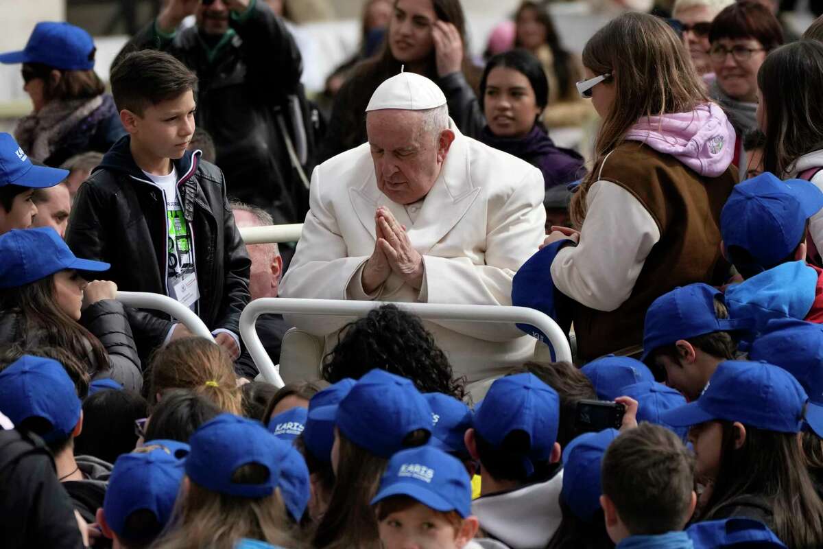 Pope Francis meets children at the end of his weekly general audience in St. Peter's Square, at the Vatican, Wednesday, March 29, 2023. Pope Francis went to a Rome hospital on Wednesday for some previously scheduled tests, slipping out of the Vatican after his general audience and before the busy start of Holy Week this Sunday.