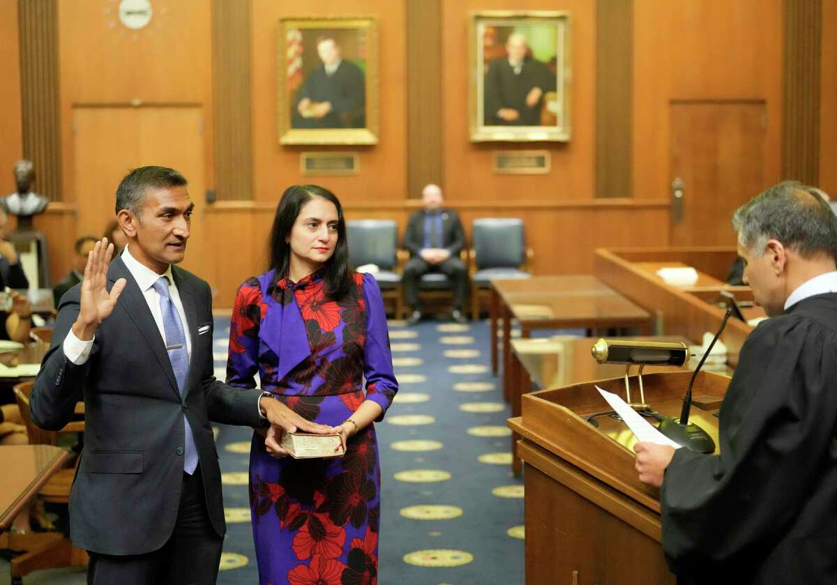U.S. Attorney for the Southern District of Texas Alamdar Hamdani, left, with his wife, Saba, takes the Oath of Office from Judge of the U.S. Court of Appeals for the Sixth Circuit Amul R. Thapar during his investiture ceremony held at the Bob Casey, 515 Rusk Ave., Wednesday, March 29, 2023, in Houston.