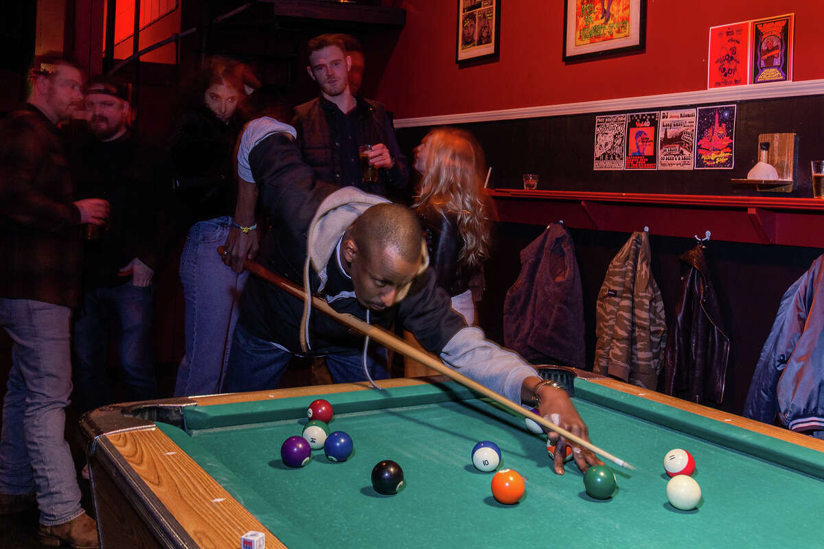 Isaac lines up a shot at Kilowatt in the Mission District on Friday night, March 10, 2023.