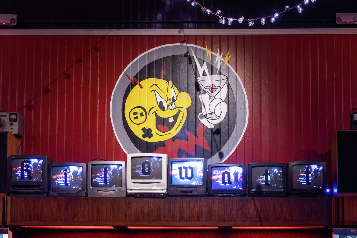Vintage DVD/VCR combo players connect to a row of old-school TVs above the bar playing camp and cult classics through the night at Kilowatt in San Francisco's Mission District, March 20, 2023.