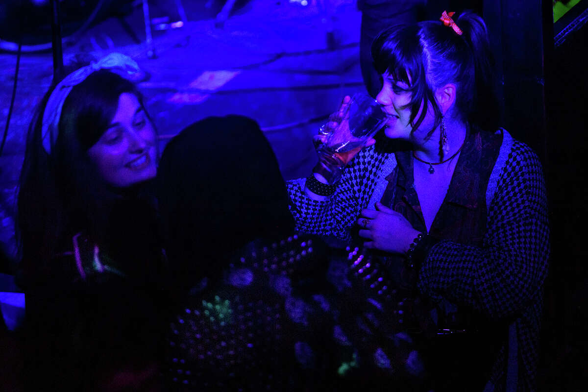 Showgoers chat between bands near the Kilowatt stage in San Francisco's Mission District on Saturday night, March 11, 2023.