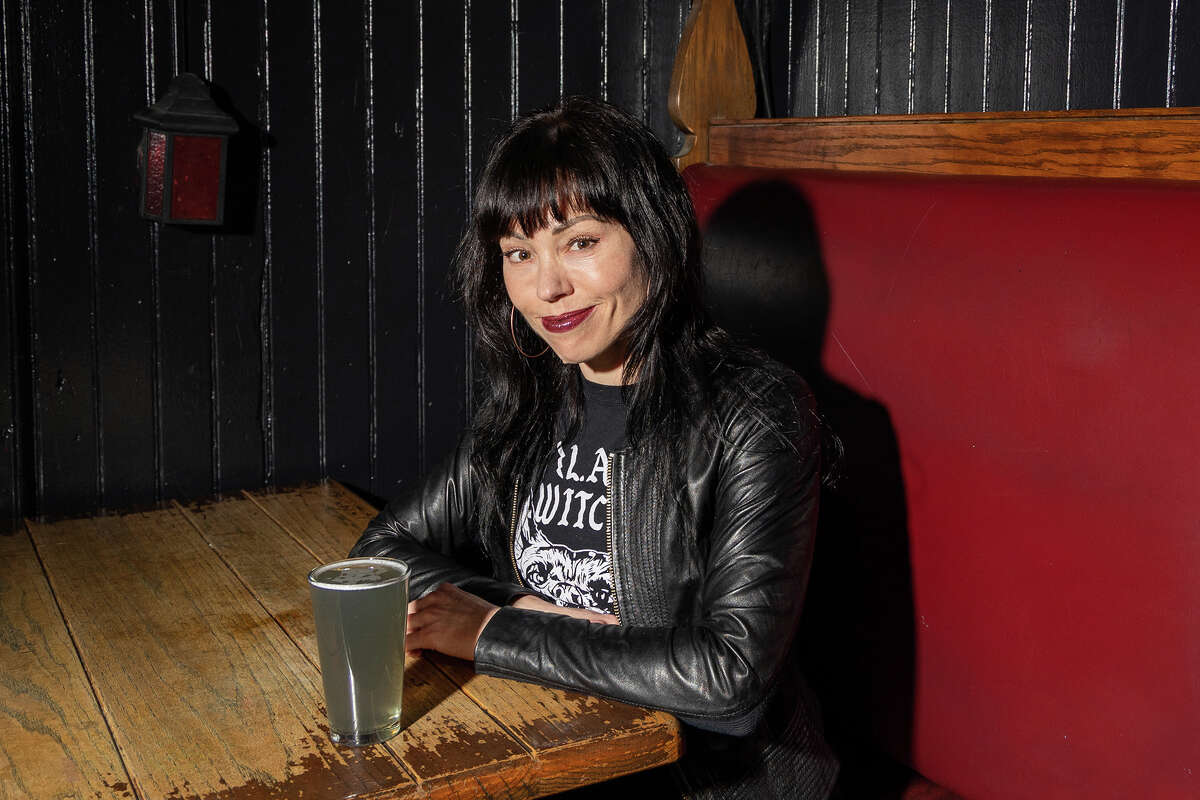 Kilowatt co-owner Katie Rose McCarthy hangs out for portraits before the evening rush at the newly revamped Mission District bar on Monday afternoon, March 20, 2023.