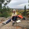 Joan Young takes a break at the junction of the Border Route and Superior Hiking Trails in Minnesota. The photo was taken while Young was hiking the North Country Trail in September 2022. 