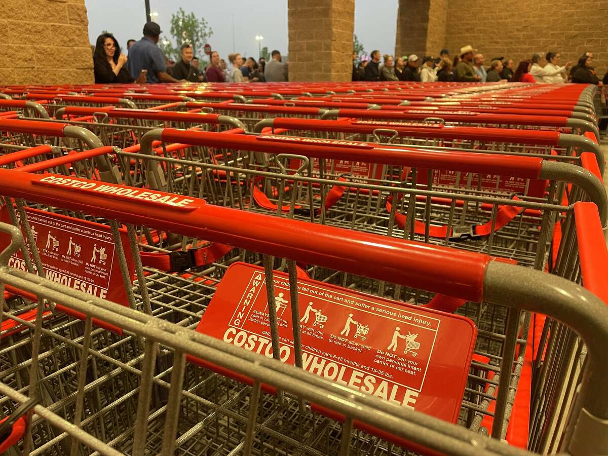 Costco employees distributed hundreds of carts in minutes to eager shoppers on Thursday.