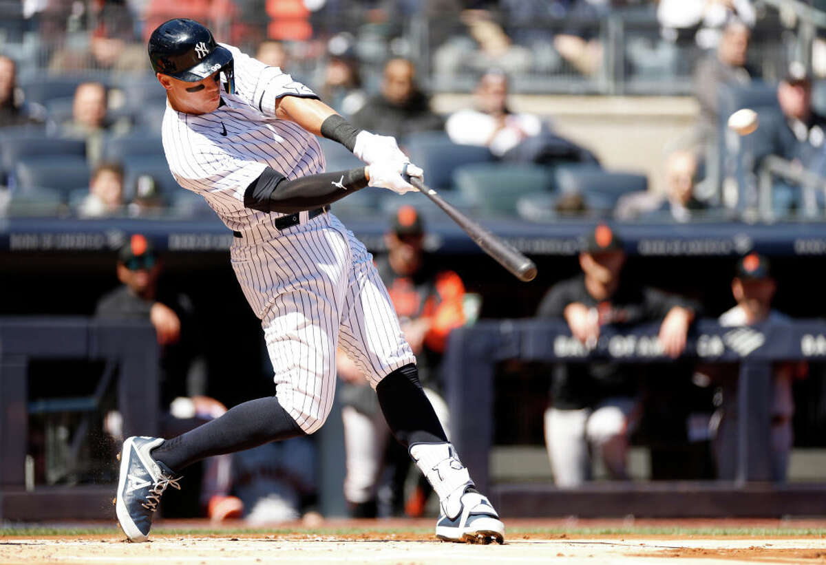 Aaron Judge hits a homer in front of the Giants dugout on March 30, 2023, at Yankees Stadium.