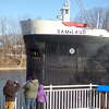A family watches as the first vessel to arrive in 2023 departs around 9 a.m. on March 30. 