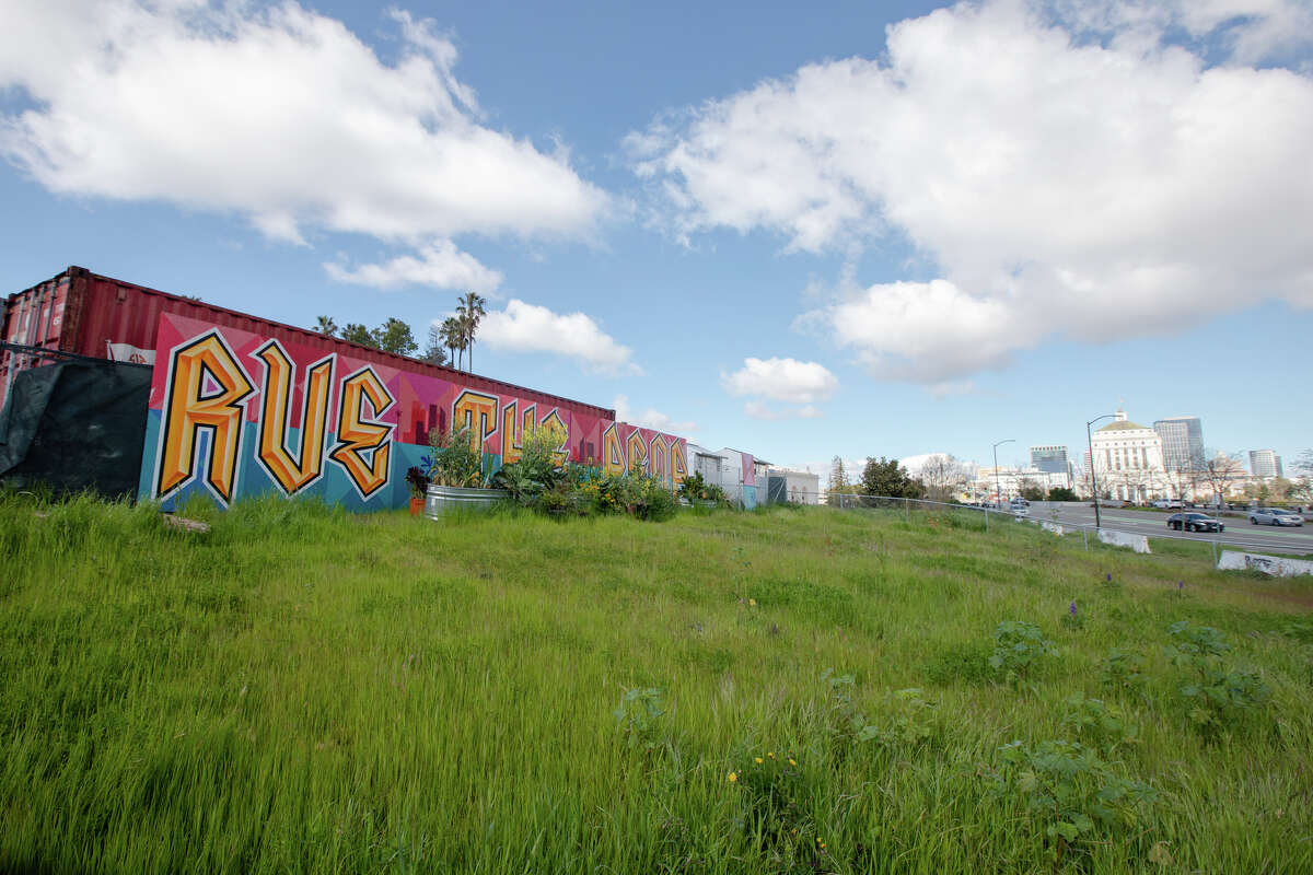 A mural on the edge of the fence of a group of tiny-home shelters for homeless people at the corner on E.12th Street near Lake Merritt in Oakland, Calif. on Mar. 30, 2023.