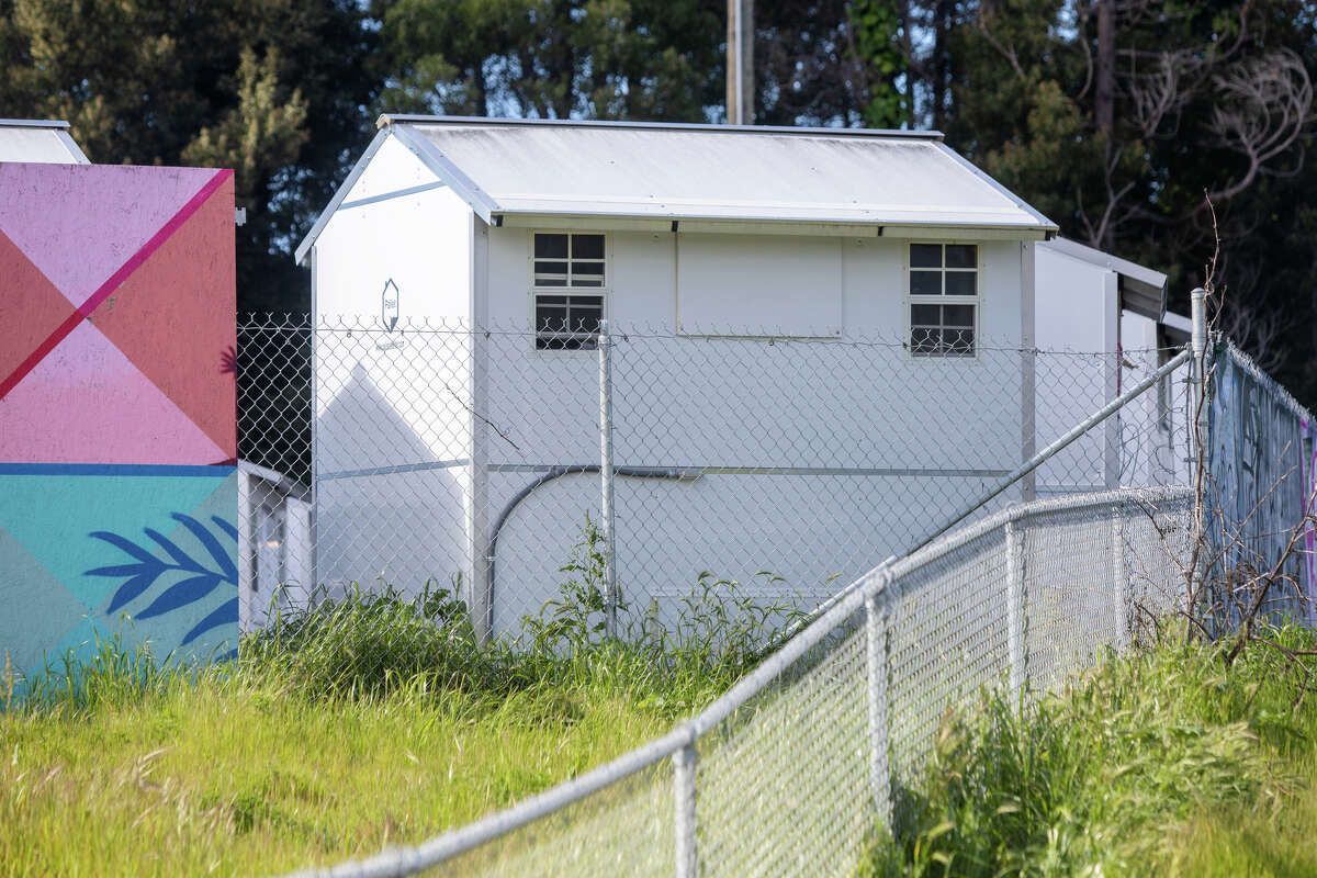 A group of tiny home shelters for homeless people at the corner on East 12th Street near Lake Merritt in Oakland, Calif., on March 30, 2023.