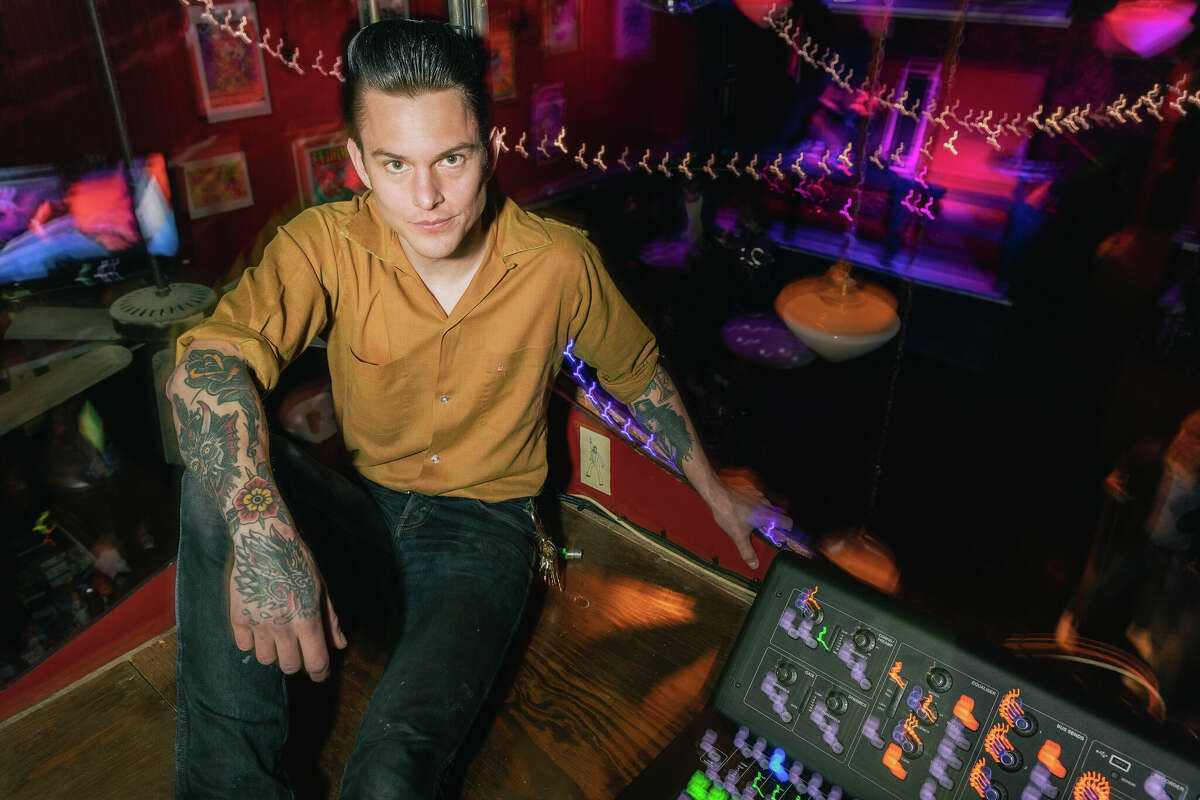Kilowatt co-owner Peter Niven posts up in the sound booth at the Mission District bar on Wednesday night, March 29, 2023.