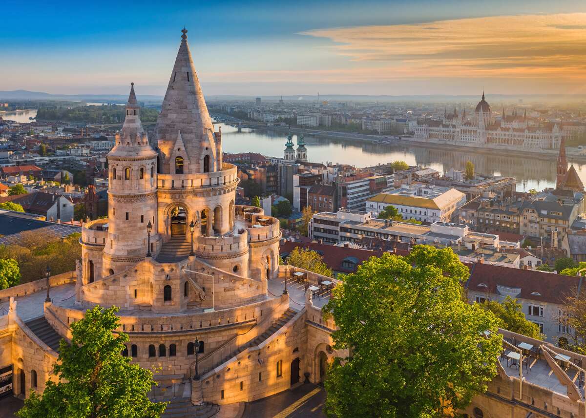 #20. Hungary - Cost index: 42.7% cheaper than the U.S. - Exchange rate: 360.29 Hungarian forints to $1 - Region: Europe Budapest, the capital of Hungary, is also the country's top tourist destination. The city is known for its thermal baths, spas, and various museums, religious sites, and theaters. Budapest is also home to eight UNESCO World Heritage Sites, including the Hungarian House of Parliament. The building took 17 years to complete and showcased local craftsmanship using only Hungarian raw materials (except for eight giant granite columns). This landmark, located on the banks of the Danube River, draws an estimated 700,000 visitors each year at about $28 per person.