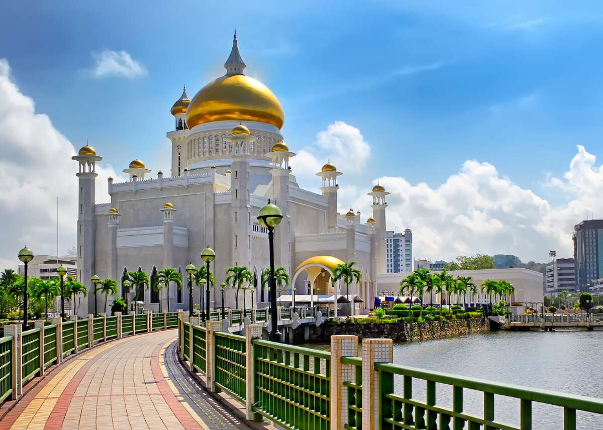 #16. Brunei - Cost index: 51.1% cheaper than the U.S. - Exchange rate: 1.35 Brunei dollars to $1 - Region: Southeast Asia Brunei is a small country on the island of Borneo where visitors can lounge on one of the many beaches dotting the 100-mile coastline or dive to explore coral reefs and shipwrecks. Almost three-quarters of the country is rainforest, which travelers can explore for free at reserves like the Luagan Lalak Forest Recreation Park, a tranquil spot famed for its serene, mirrorlike waters accessed by a network of wooden walkways. For those needing an end-of-the-year fix, the country's Brunei December Festival also offers a long list of events, including food, entertainment, and celebrations of Islamic culture in the last month of the year. You may also like: 30 incredible photos that show the true power of nature