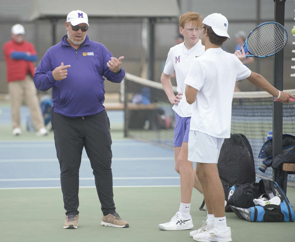 Midland High coach Tom Heiting talks to doubles team Jack Robertson, middle, and Sonny Brown during the District 2-6A Tennis Tournament, March 30 at Bush Tennis Center. 