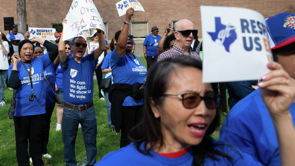 Members of Houston Federation of Teachers cheer while President Jackie Anderson speaking against the state takeover of HISD at a rally, hosted by The Greater Houston Justice Coalition and other community groups Friday, March 31, 2023, at Cesar Chavez High School in Houston.